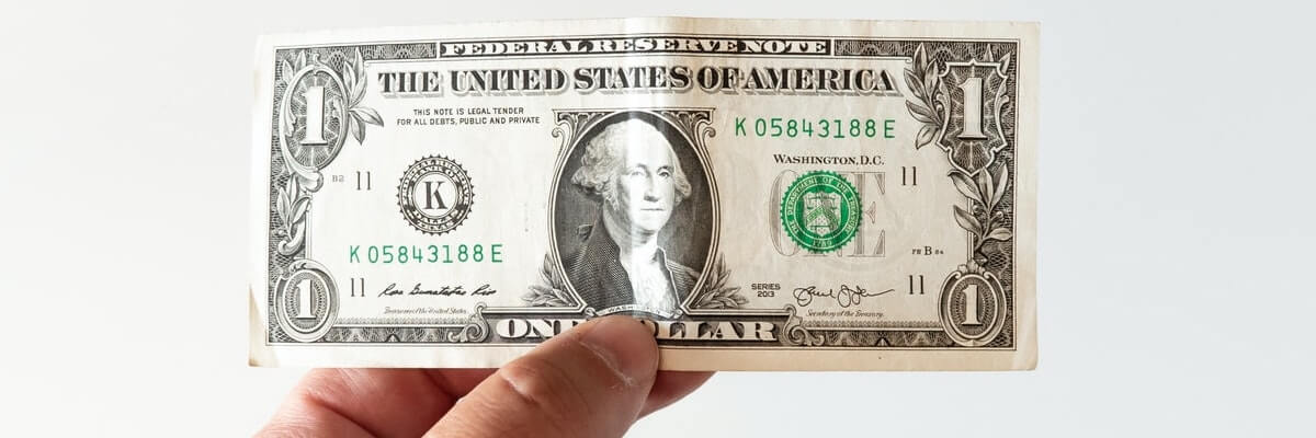 hand holding a one dollar bill