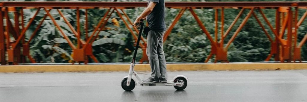 man riding rental scooter