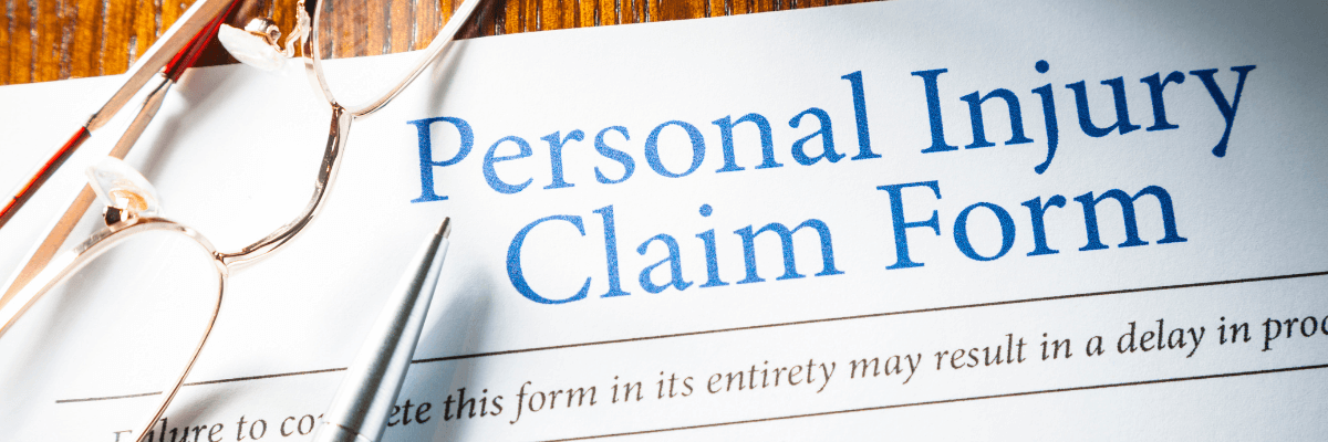 personal injury claim form on white paper with blue lettering.