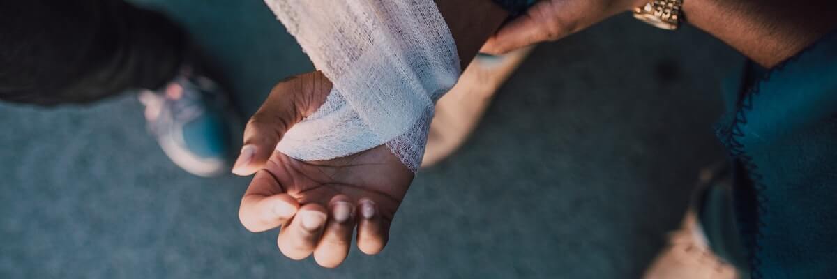 injured hand being bandaged