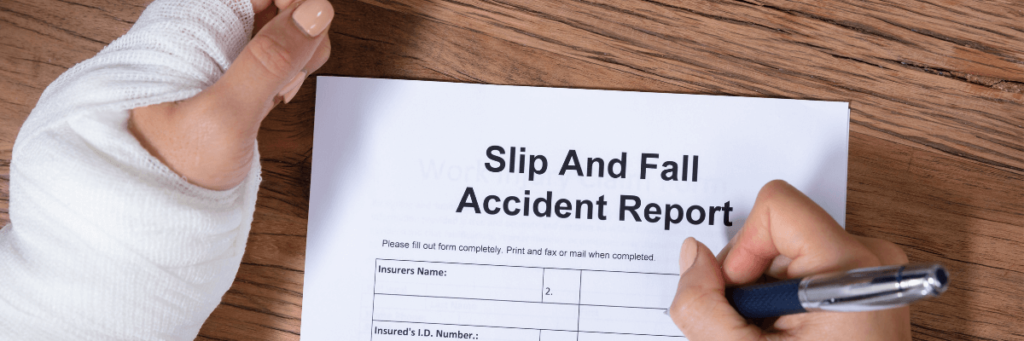 a person wearing a cast on their left arm is filling out a form with the right hand. The form is titled 'Slip and Fall Accident Report'